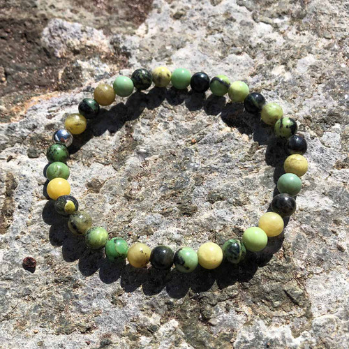 Chrysoprase 6mm bead stretch bracelet resting on rock ledge